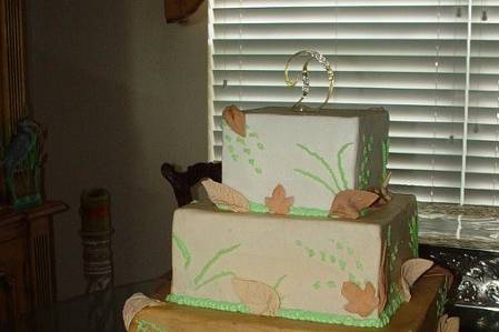 Four tier buttercream, in shades of brown to tan, with Fall design and gum paste leaves.