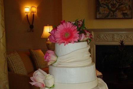 Three tier buttercream with fondant band and drapings accented with flowers. Reception held at King and Prince Resort on St. Simons Island, Ga.