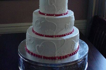 Three tier buttercream accented with heart design. Reception held in Fernandina Beach Fl.