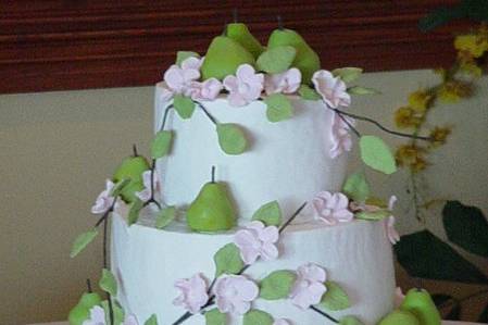 Three tier buttercream with fondant pears and vines of flowers.