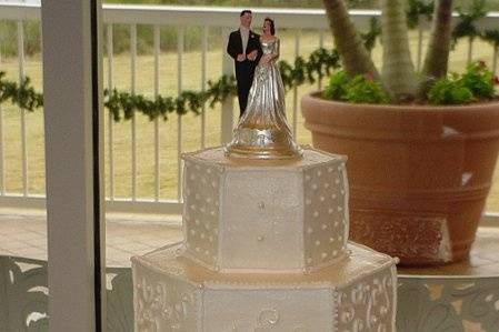 Three tier buttercream, hexagon shape with alternating designs, and pearl dusting. Reception held on St. Simons Island, Ga.