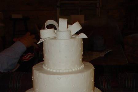 60th Wedding Anniversary: Three tier buttercream with various designs and fondant bow.