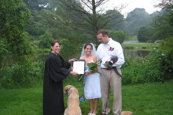 Newlyweds, their dog, and their officiant