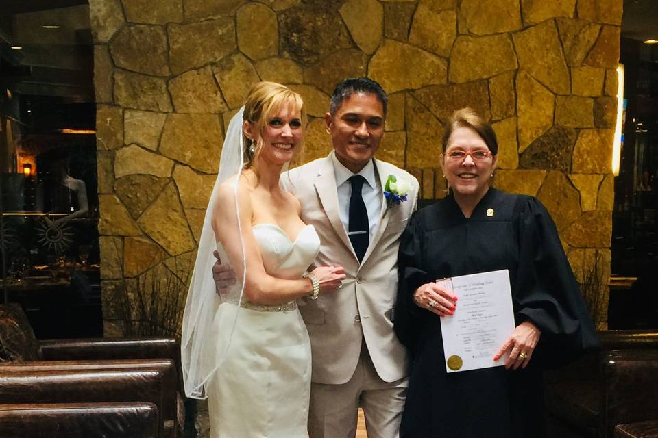 newlyweds with their officiant