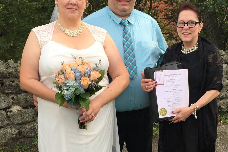 Bride and groom with the officiant