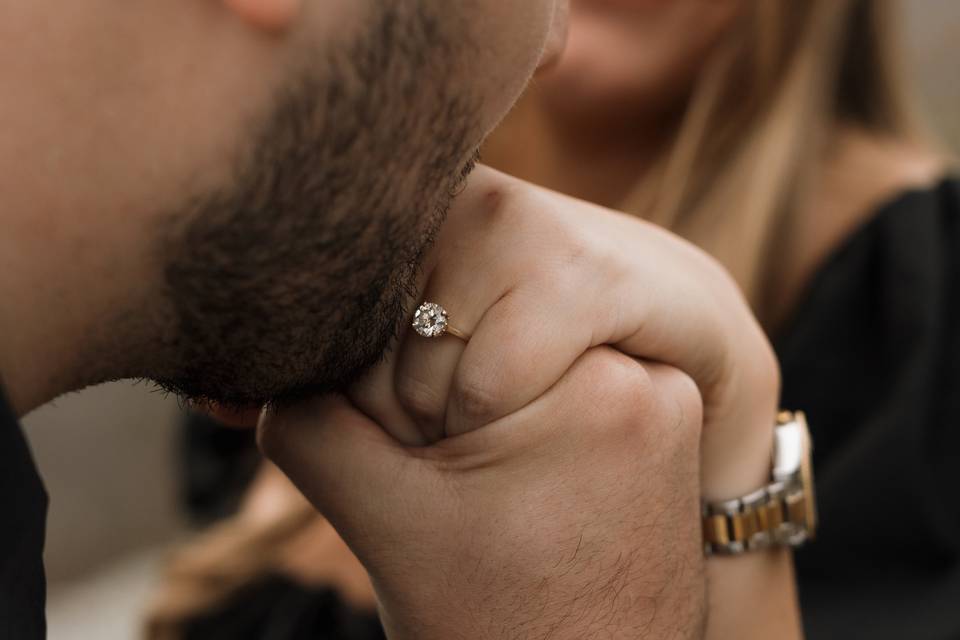 Man kissing fiances hand