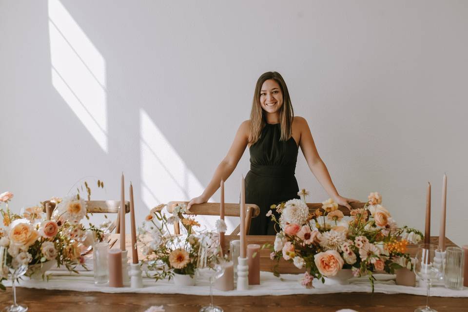 Becca standing behind table