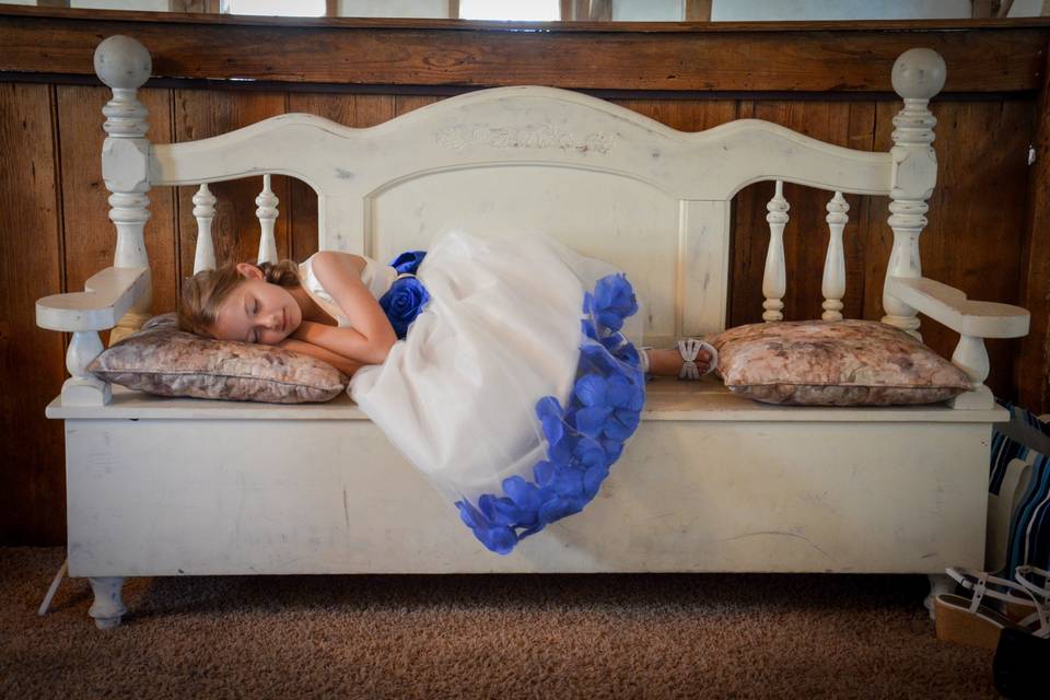 I love this picture...This flower girl just had to lay down after that big walk down the isle!