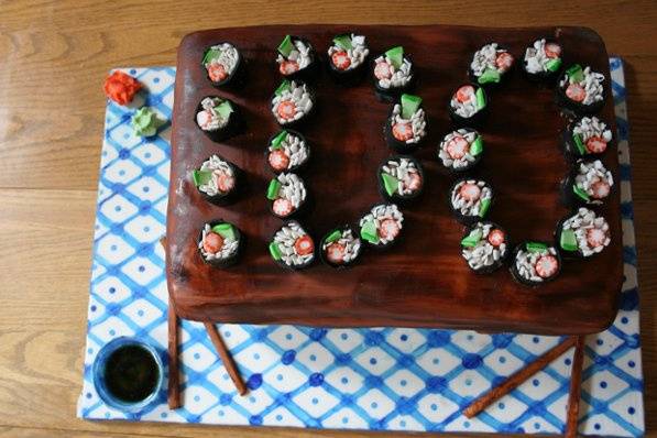 Grooms cake for a groom who proposed with sushi arranged to say 
