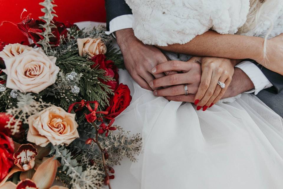 The couple wearing their wedding rings