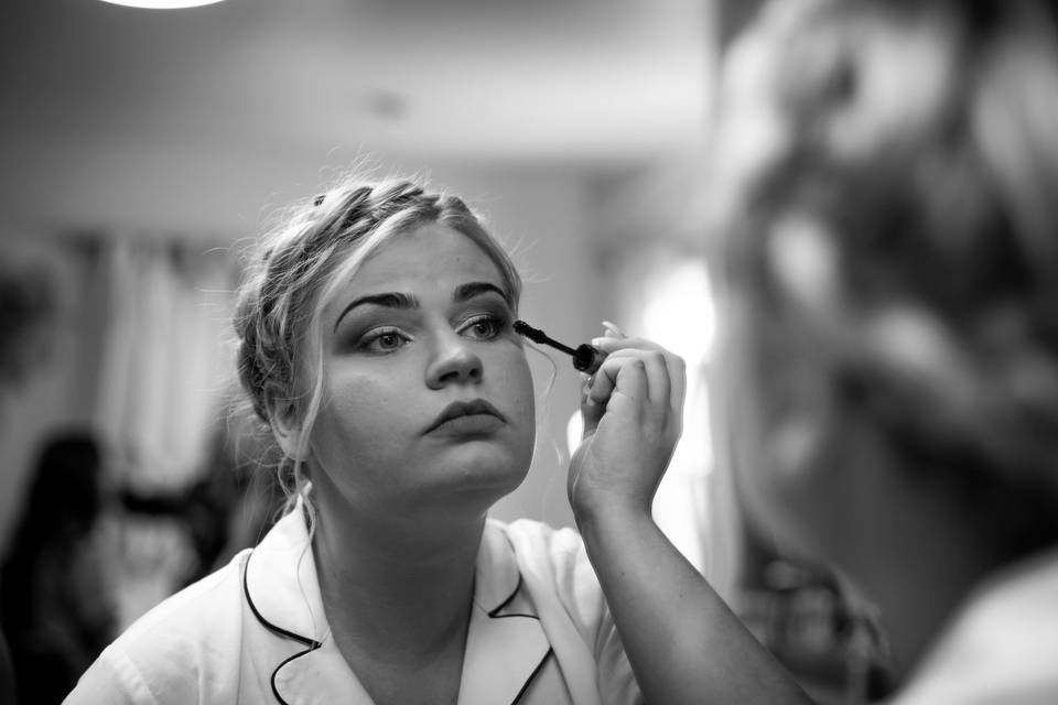 Bride applying her makeup
