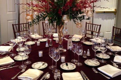 Round table setup with red flowers