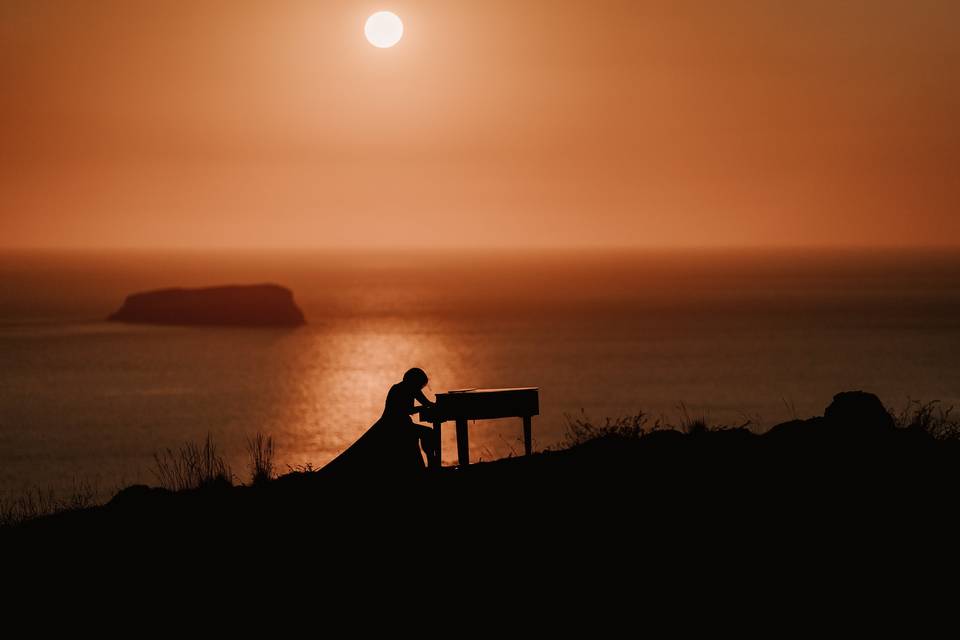 playing piano by sunset