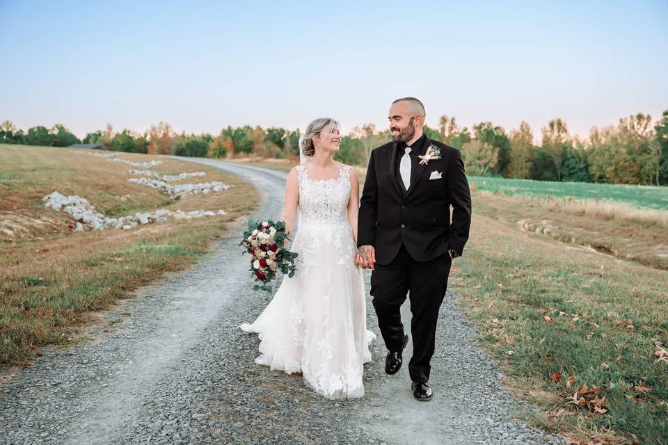 Couple walking down gravel pat