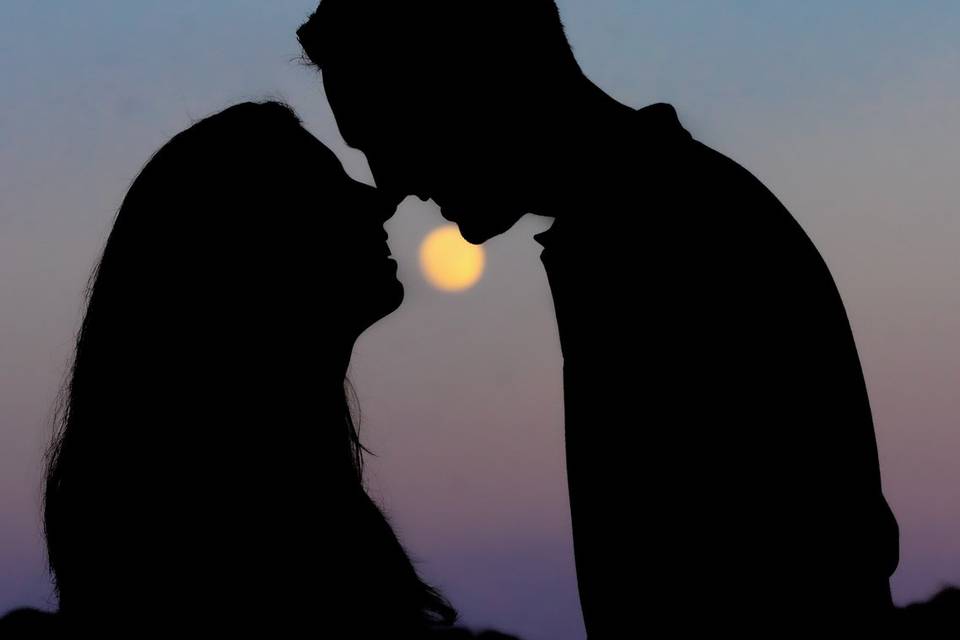 Silhouette of couple and moon