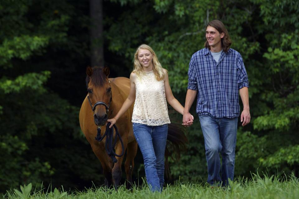 Couple walking with a horse