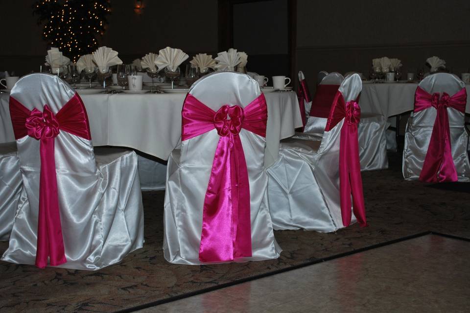 White chairs with pink bows