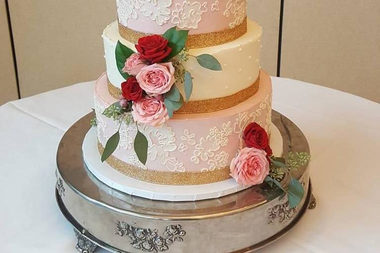 Pink and white cake with rose decorations