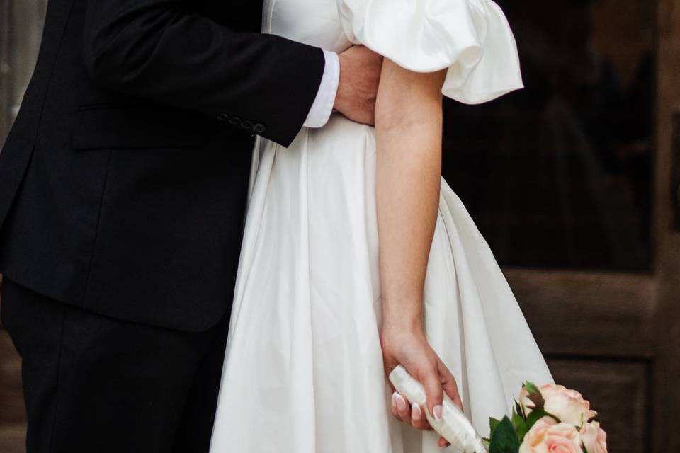 Groom kissing bride's neck