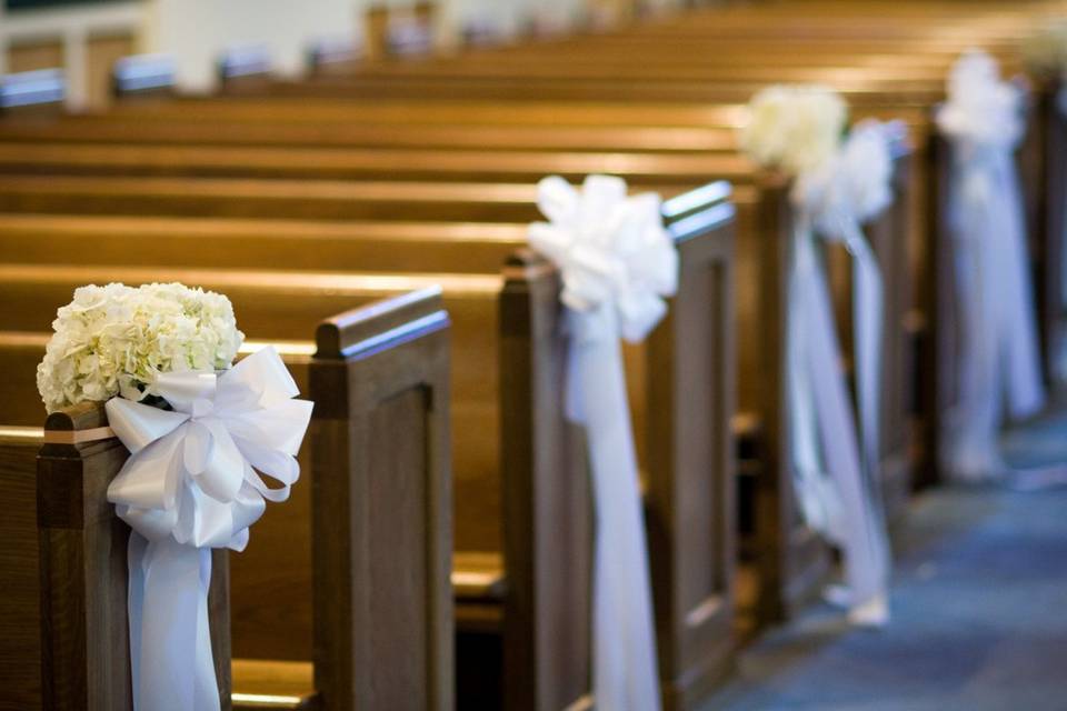 Floral pew decor with ribbons