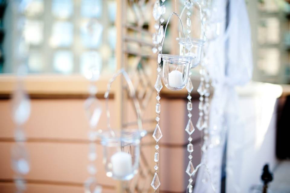 Hanging tea lights and beads for an elegant outdoor ceremony