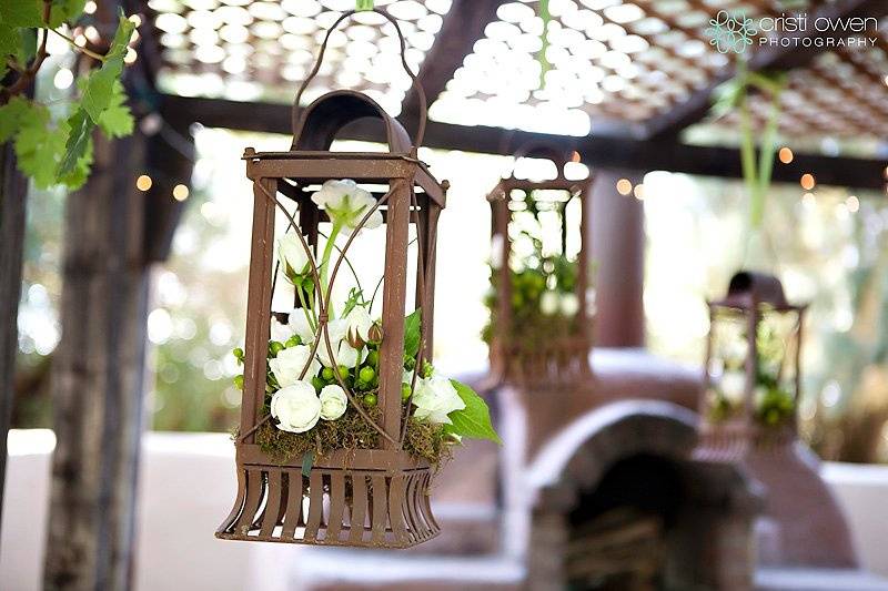Rustic lanterns are filled with moss and flowers for an outdoor ceremonyCactus Flower, Phoenix, AZ