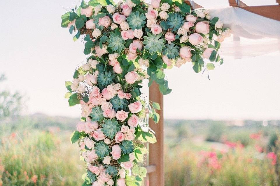 Arbor décor with succulents and roses.