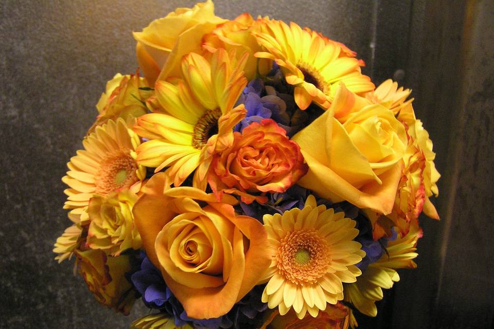 Yellow flower arrangement with purple notes
