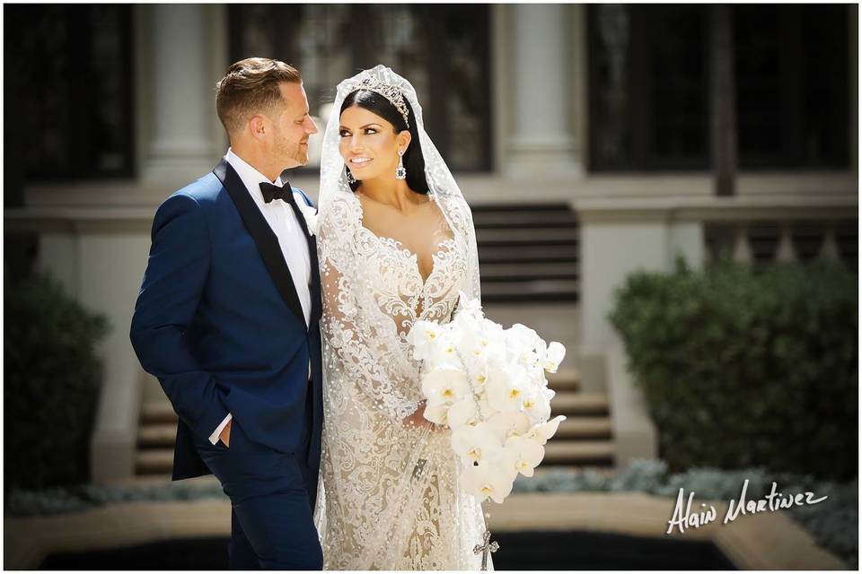 Navy tuxedo and lace wedding dress