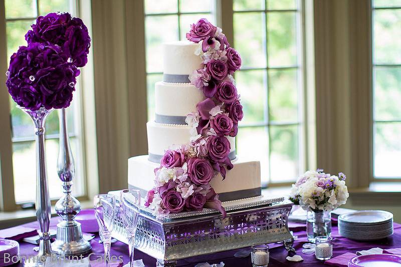 Simple buttercream wedding cake with fresh flowers