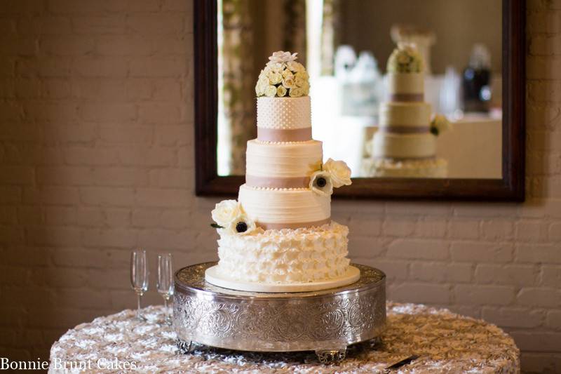3-tier wedding cake with a gold top layer