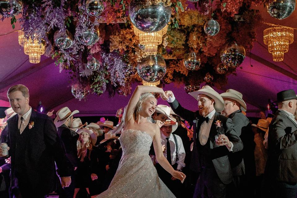 Bride dance under disco balls