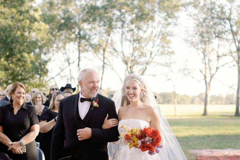 Father walking bride down aisl