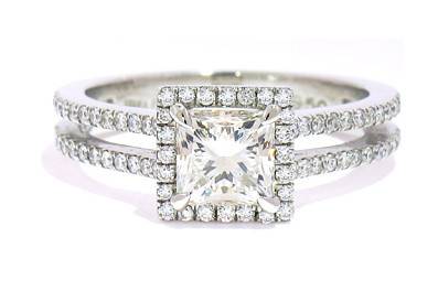 Princess cut diamond engagement ring with a diamond halo and split band in platinum.