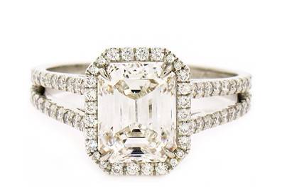 Emerald cut diamond with micro pave halo on a split shank band in platinum