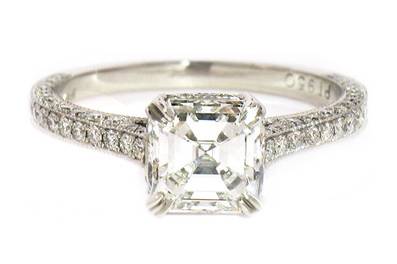 Asscher cut solitaire with three side pave diamond band in platinum.