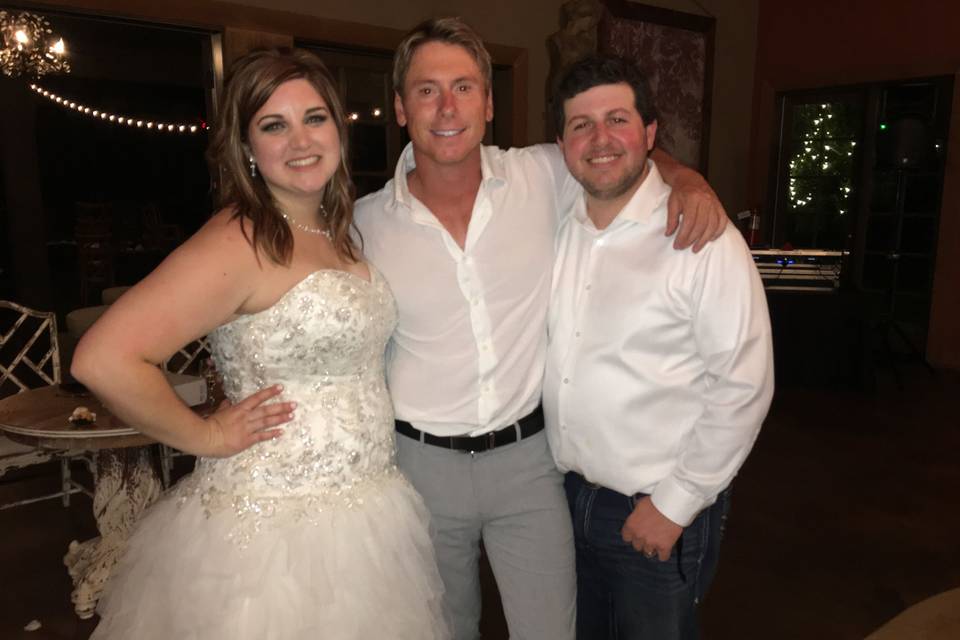 The newlyweds posing with the DJ
