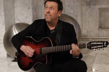 George Cole with guitar