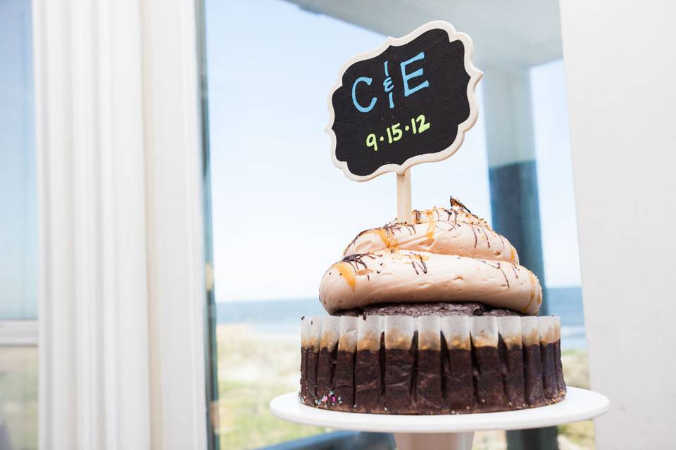 A mega wedding cupcake for cutting beside the beach