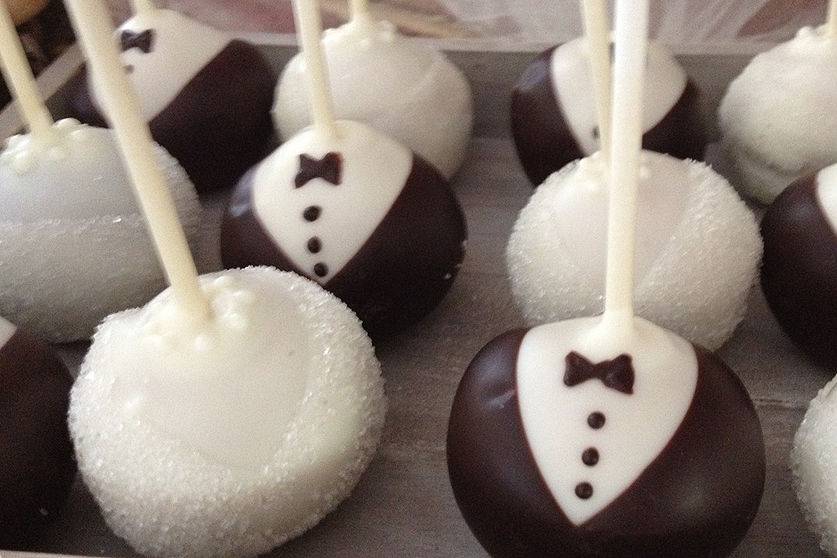 Bride & groom cake pops lined up in rows