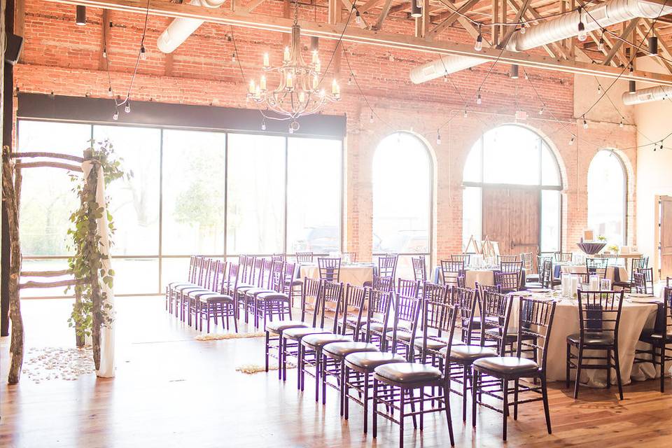 Exposed brick, hardwood floors and lots of natural light make Cross + Main a perfect ceremony and reception venue. Photo by Anna Holcombe.