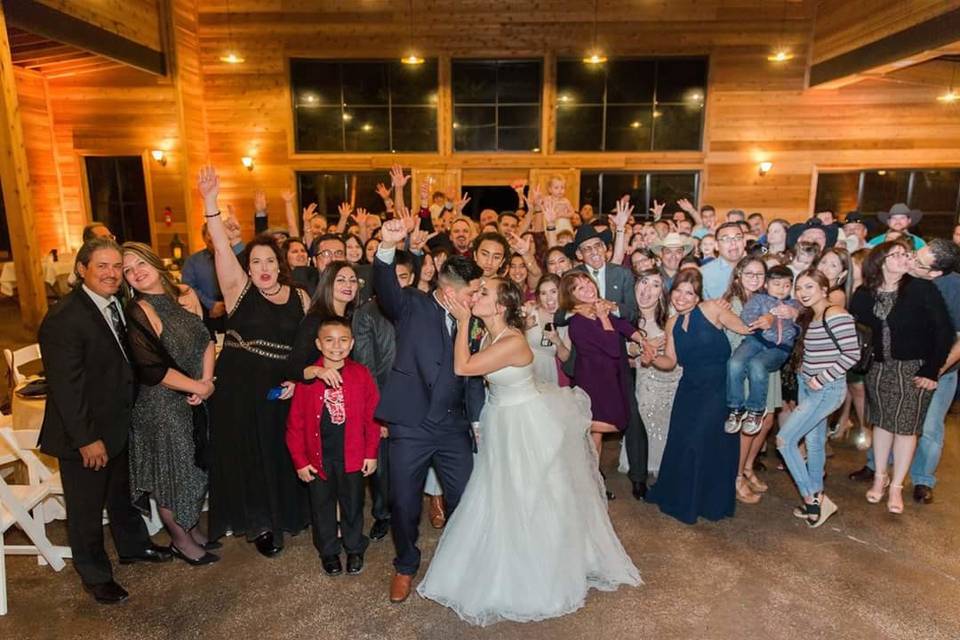 The couple dancing with guests