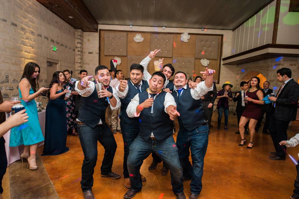 The groom dancing with his bestman