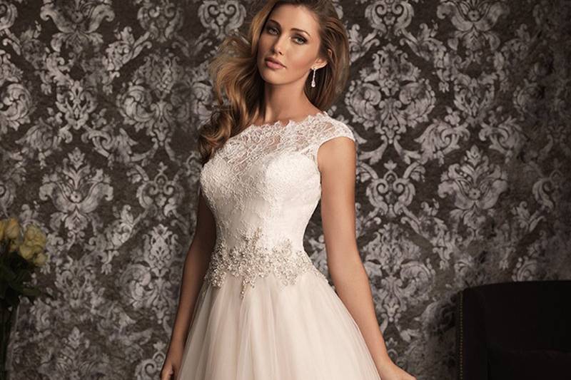 Style No. 9022 <br>
Romantic and classic. This ball gown combines lace and English Net perfectly. The lace bodice features a scoop neckline with cap sleeves while Swarovski crystals accent the waistline. The back has a lovely keyhole detail while a soft gathered skirt finishes the style.