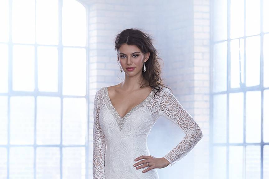 Style MJ162 <br> Swarovski crystals line the neckline and back of this slim-fitting lacy sheath.