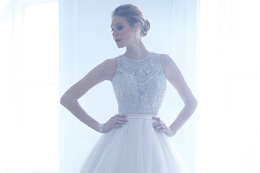 Style MJ168 <br> This figure-skimming strapless gown is simple and romantic, featuring all-over lace.