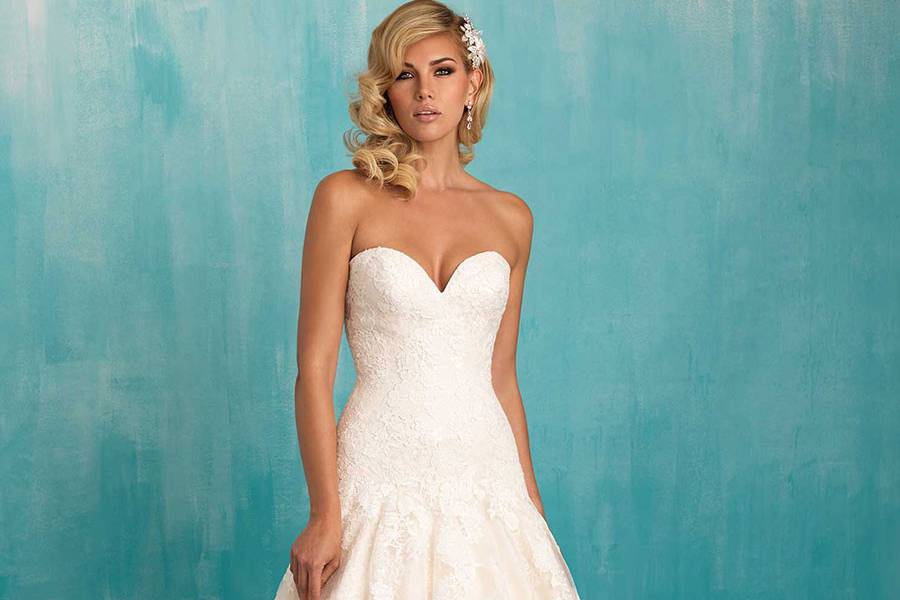 Style 9314 <br> This strapless gown's lace bodice trails floral appliques to a full skirt.