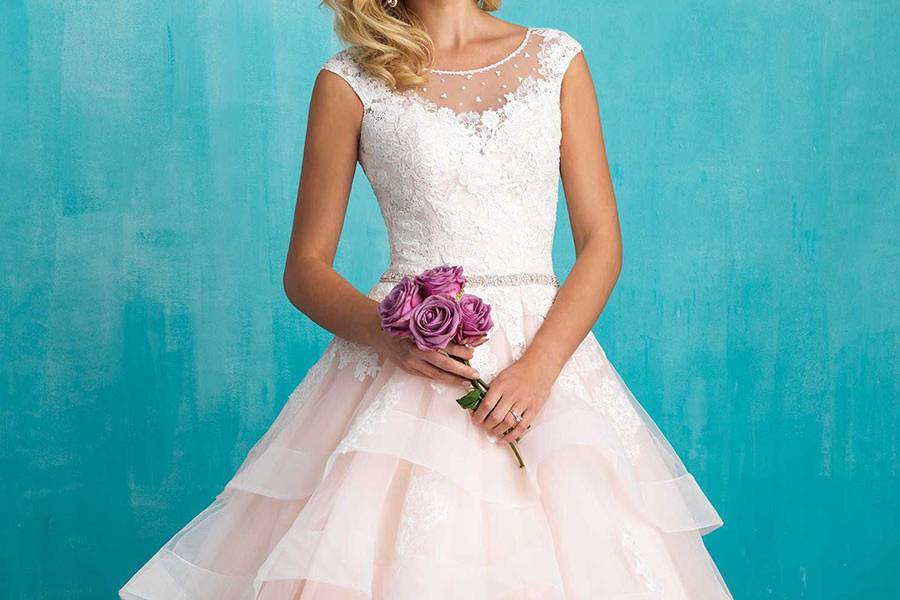 Style 9320 <br> Classic lace composes this simple yet striking gown.