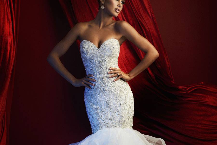 Style C367 <br> Statuesque and lovely, this strapless column gown is adorned with a sweep of ruffles at the hem.