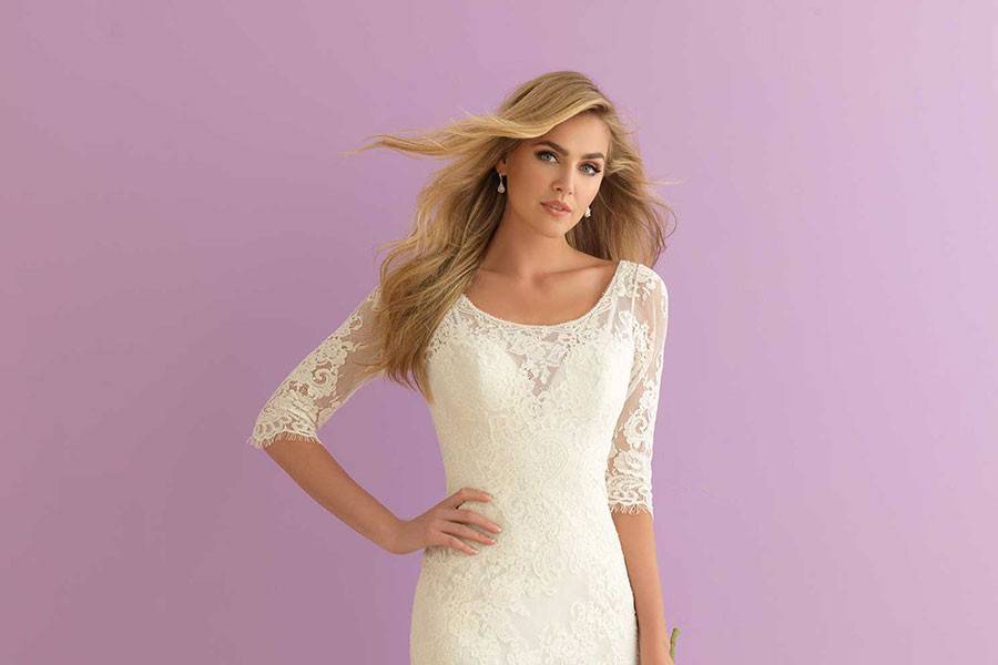 Style 2910 <br> Elbow-length sleeves ensure this slim lace sheath is the perfect choice for any season.